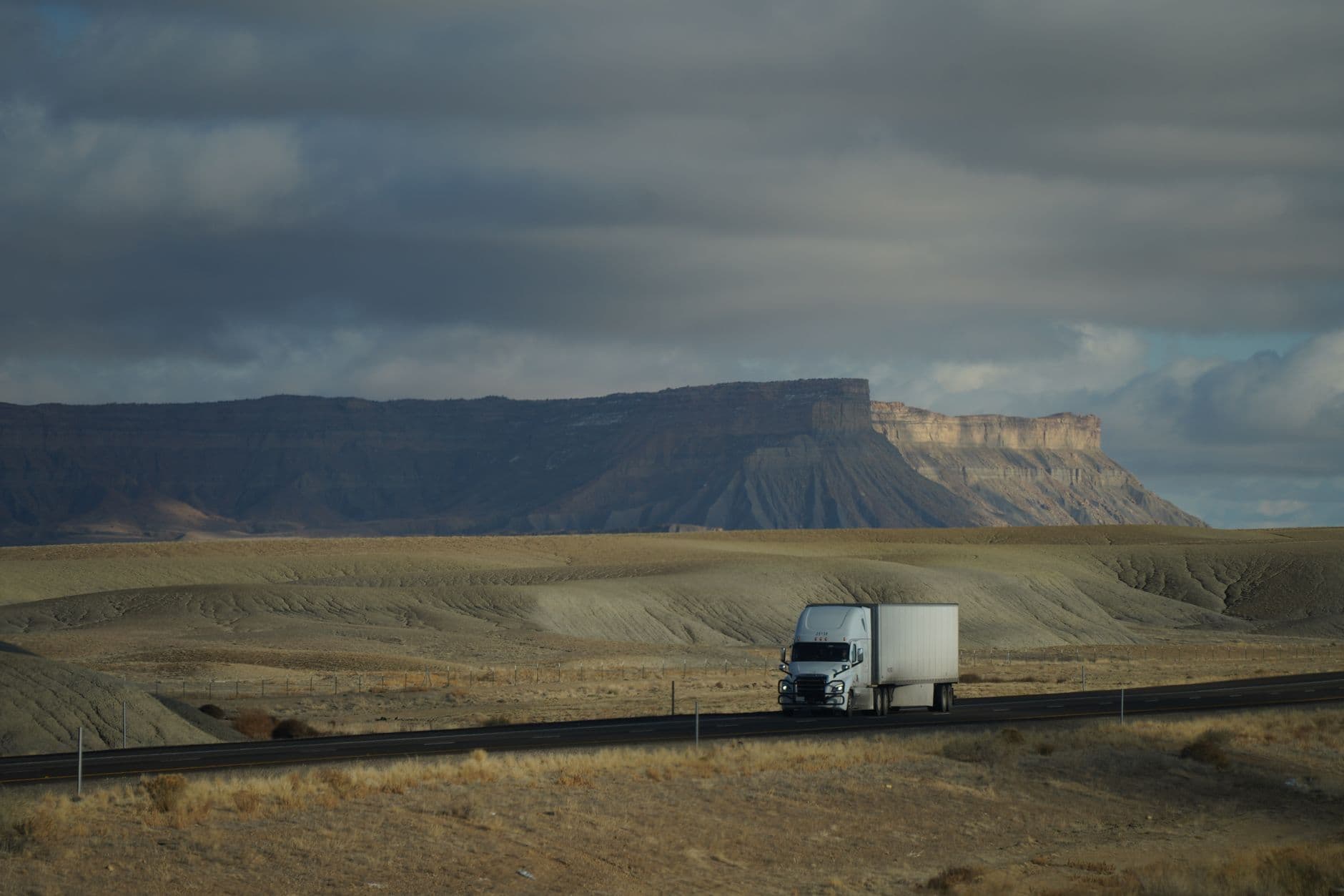 A semi truck traveling along an open highway representing carrier freight operations