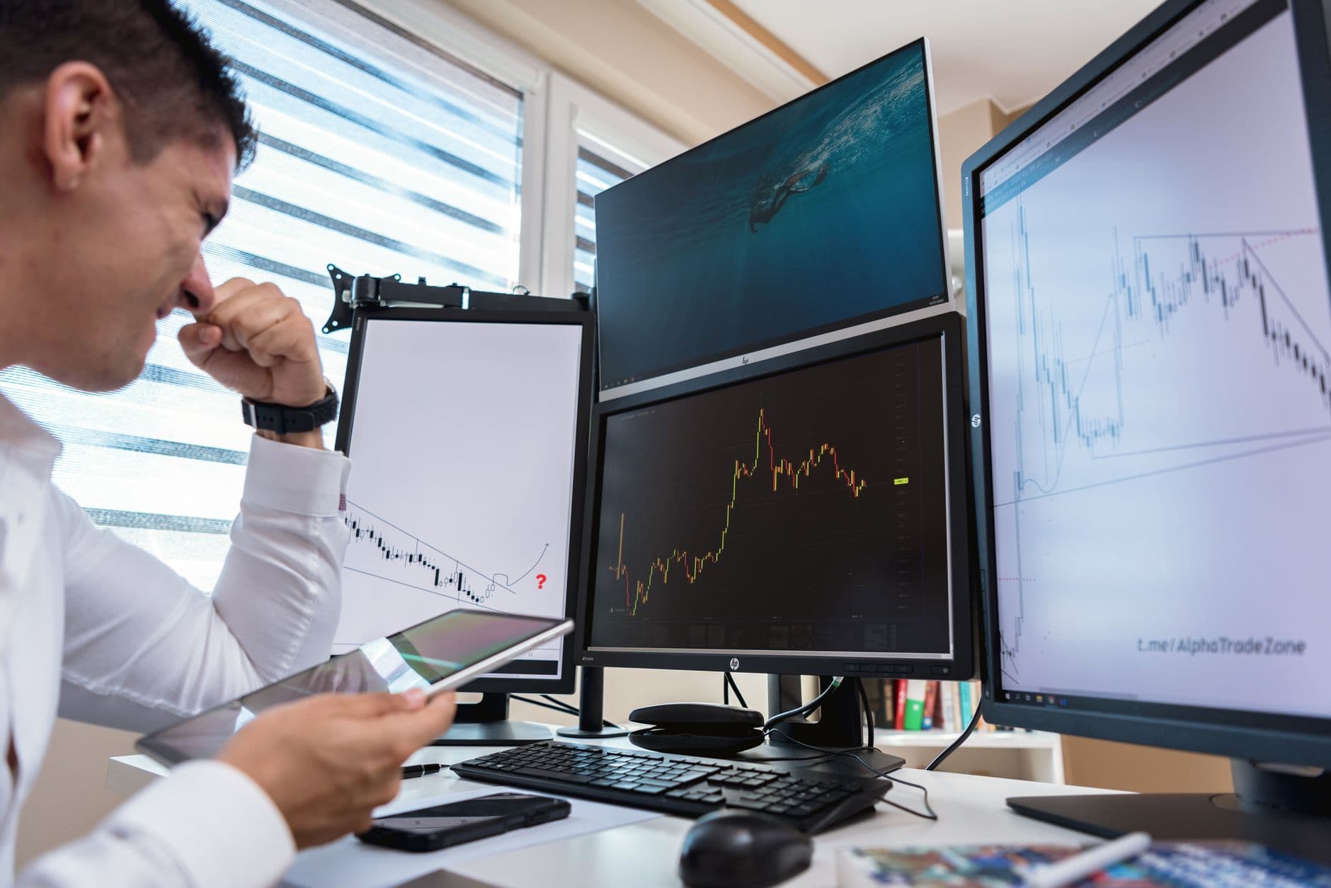 Freight broker reviewing shipper contacts on a dual monitor desk setup