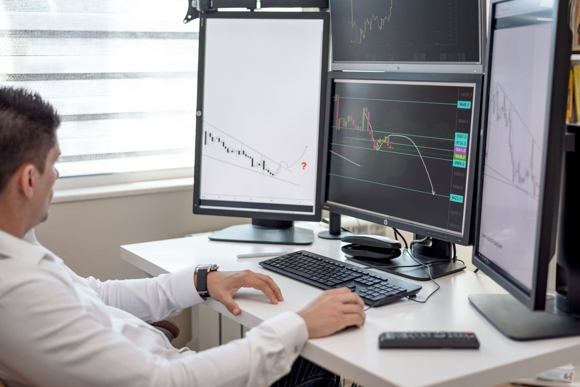 A freight broker's desk with multiple screens showing shipment and outreach data