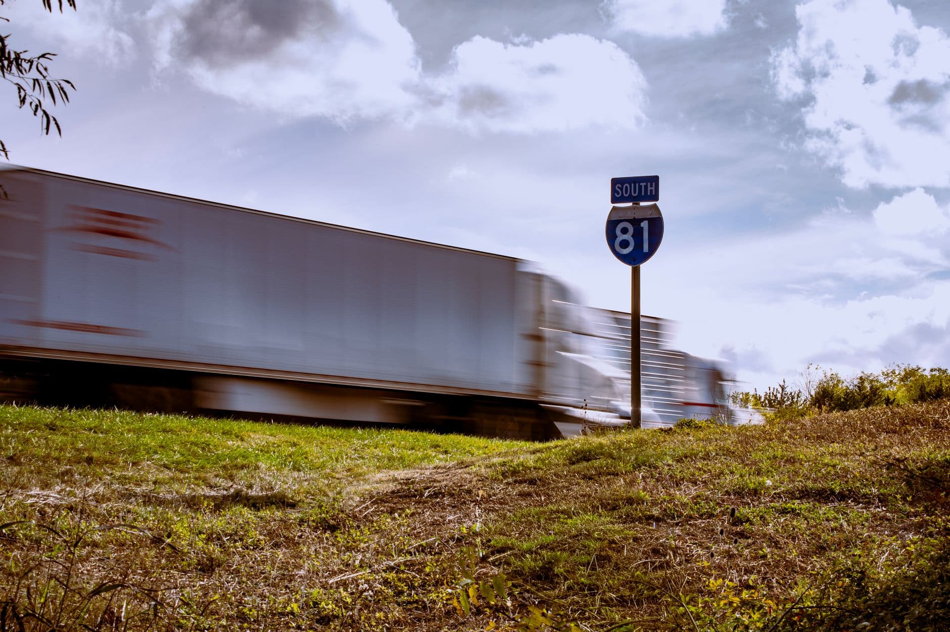 Aerial view of a freight truck on a highway corridor representing lane-based outreach