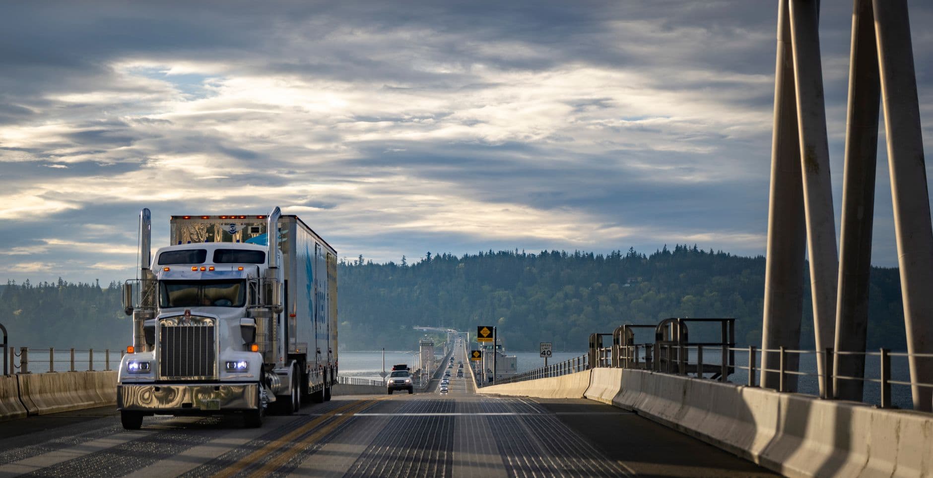 A freight truck driving on a highway at dawn, representing logistics outreach and new campaign readiness