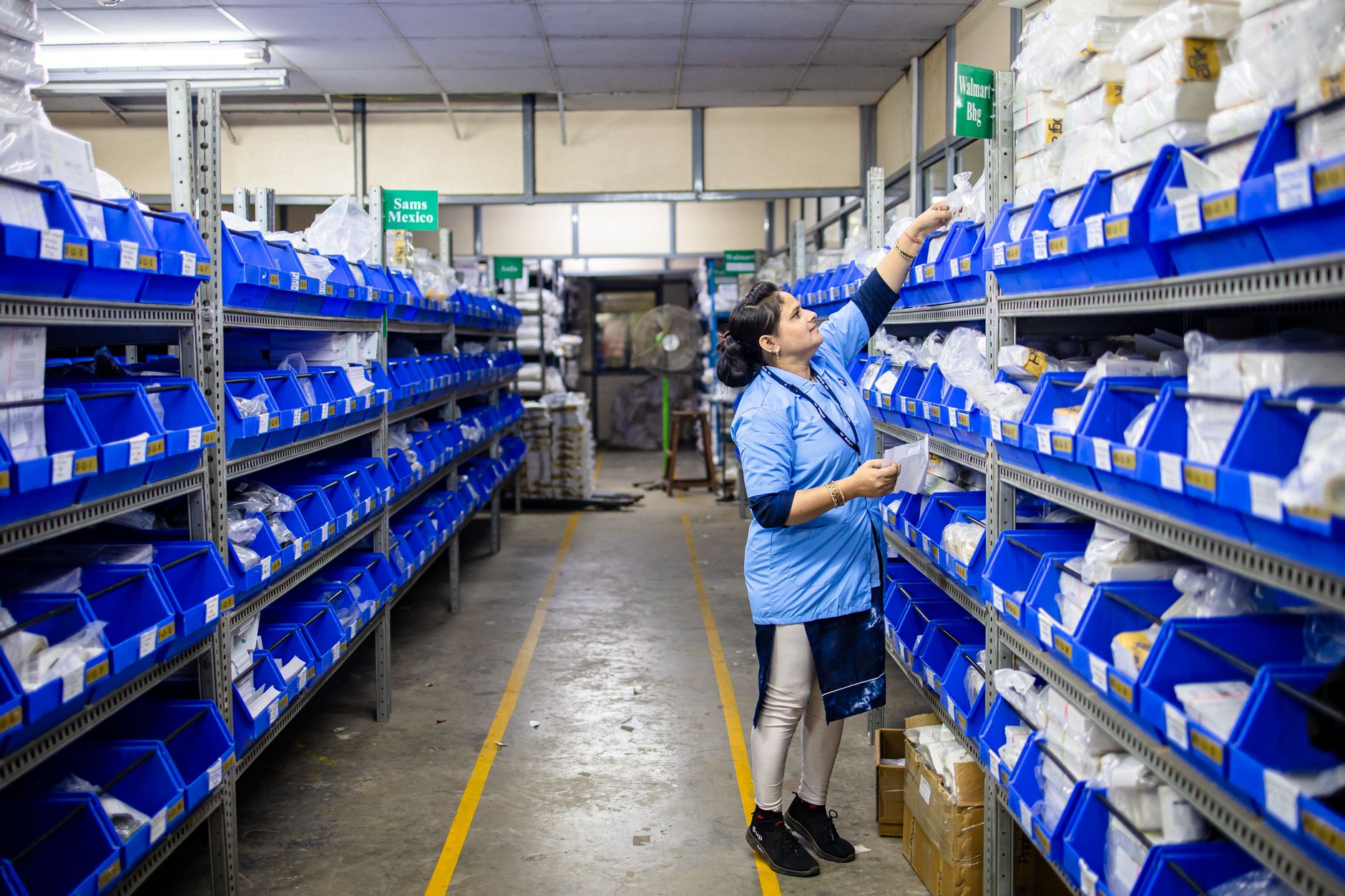 Workers managing shipments on a busy warehouse operations floor
