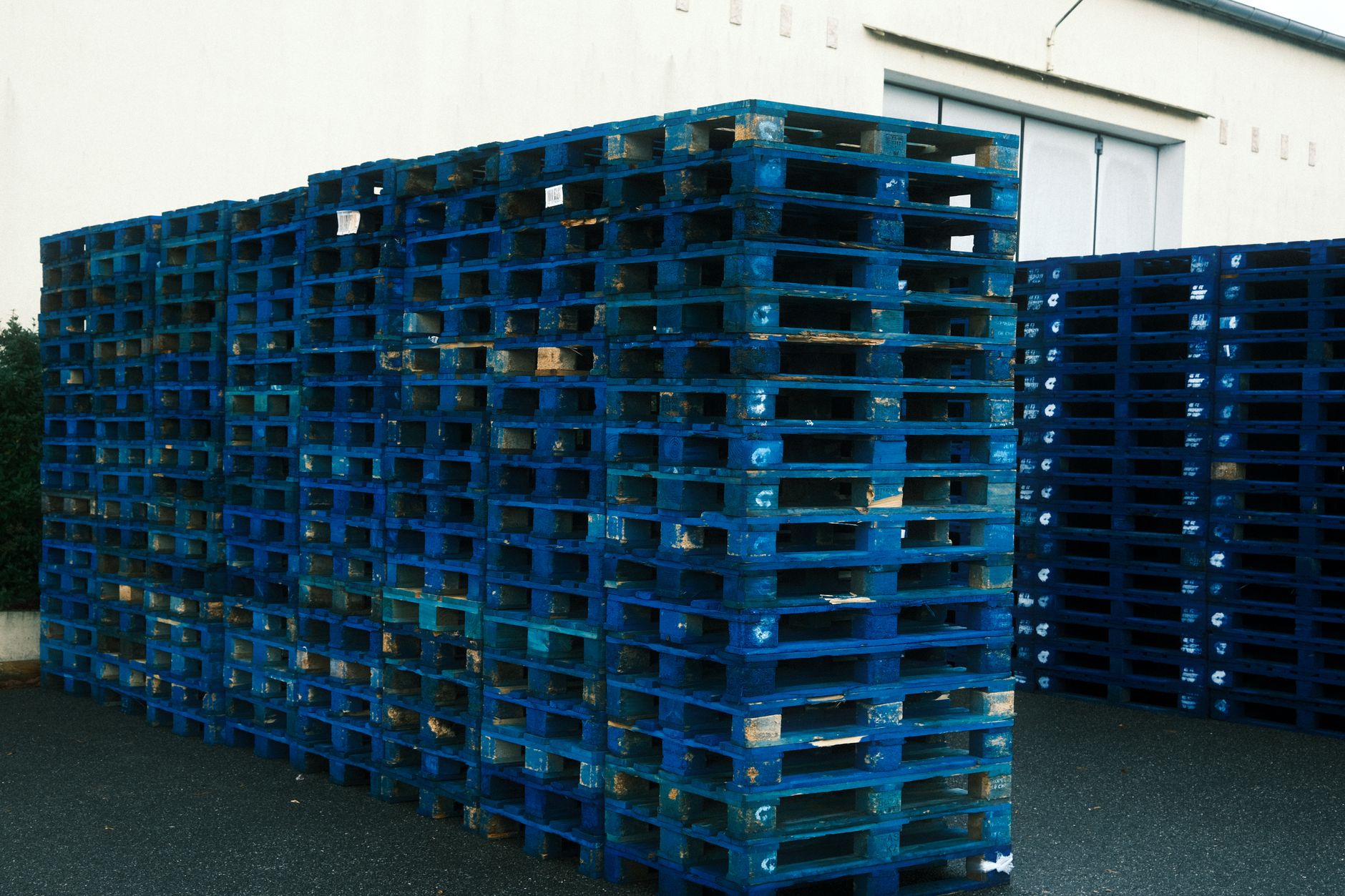 Workers loading cargo pallets at a busy warehouse loading dock