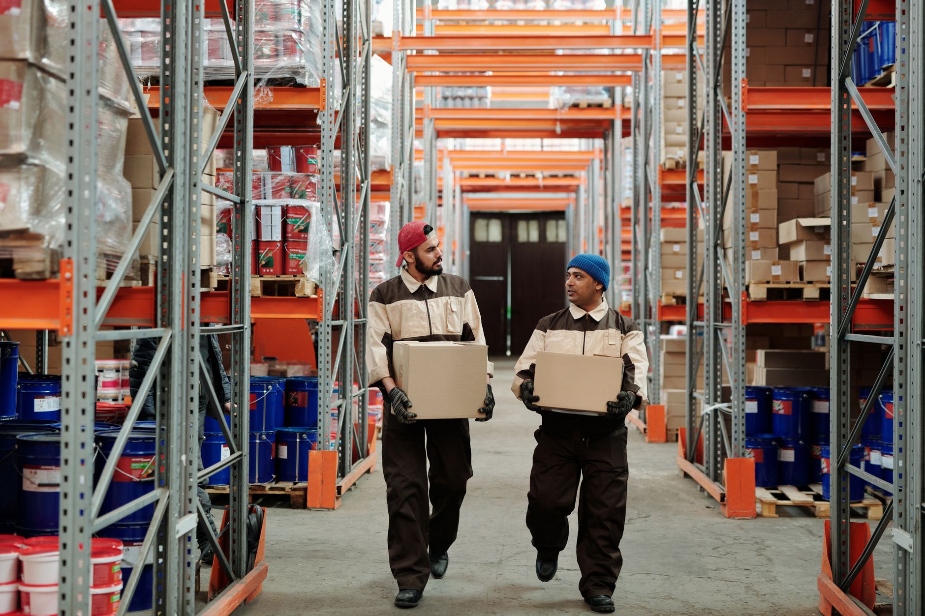 Workers sorting parcels on a conveyor belt inside a fulfillment center