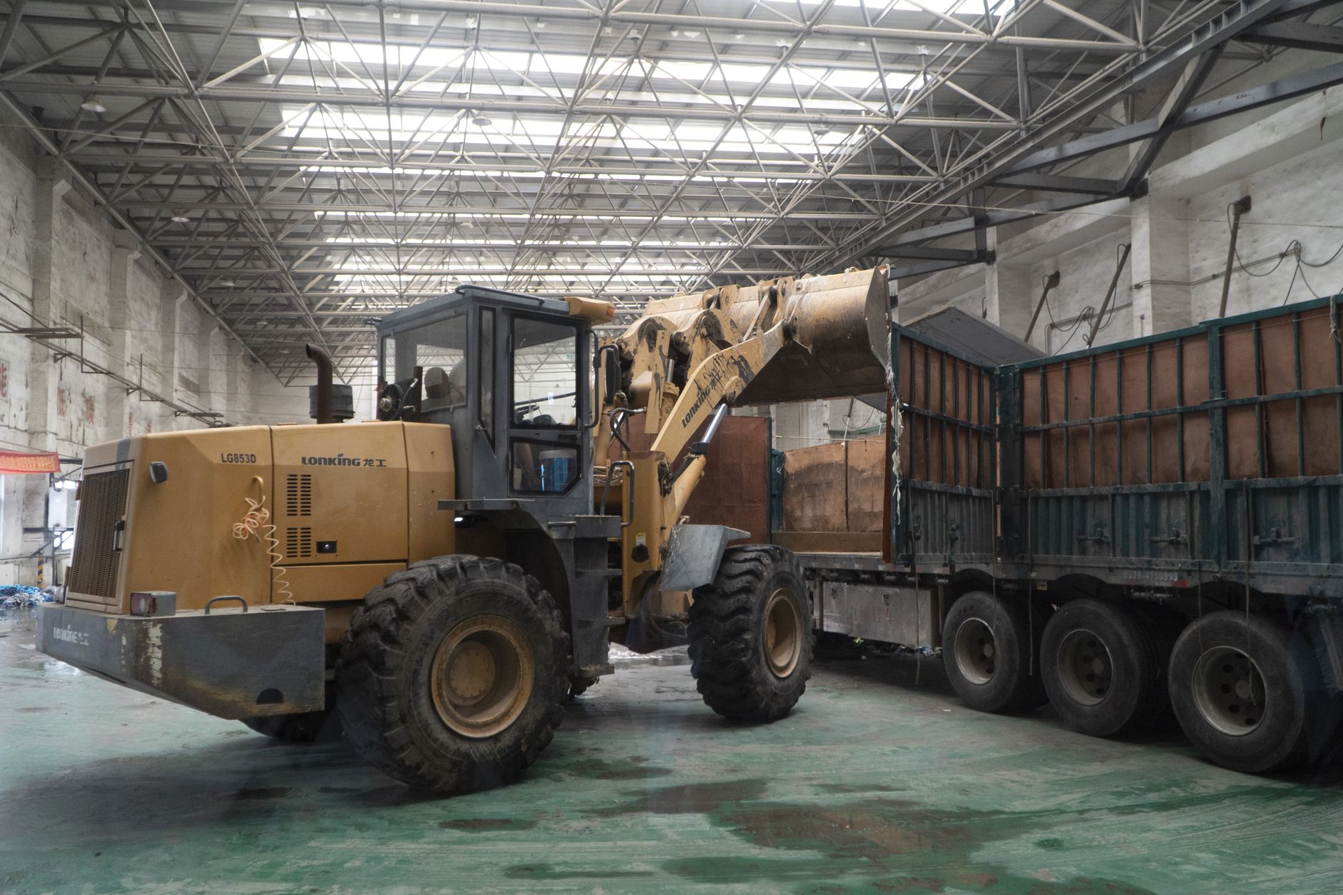 Trucks backed into loading dock bays at a distribution warehouse