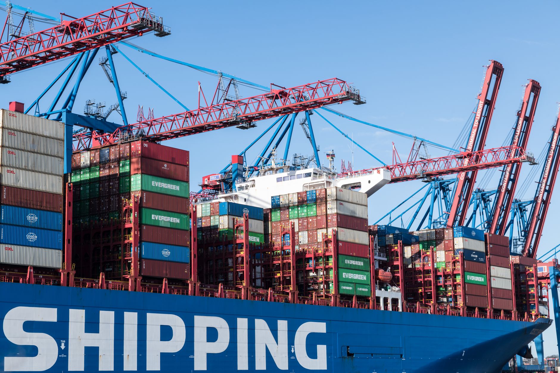 Cargo ship being loaded with containers at a commercial dock