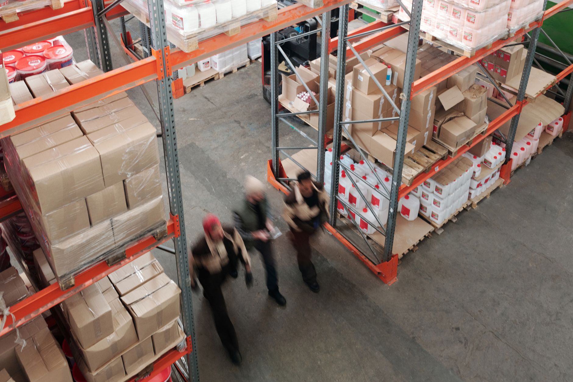 Workers managing inventory in a busy freight warehouse
