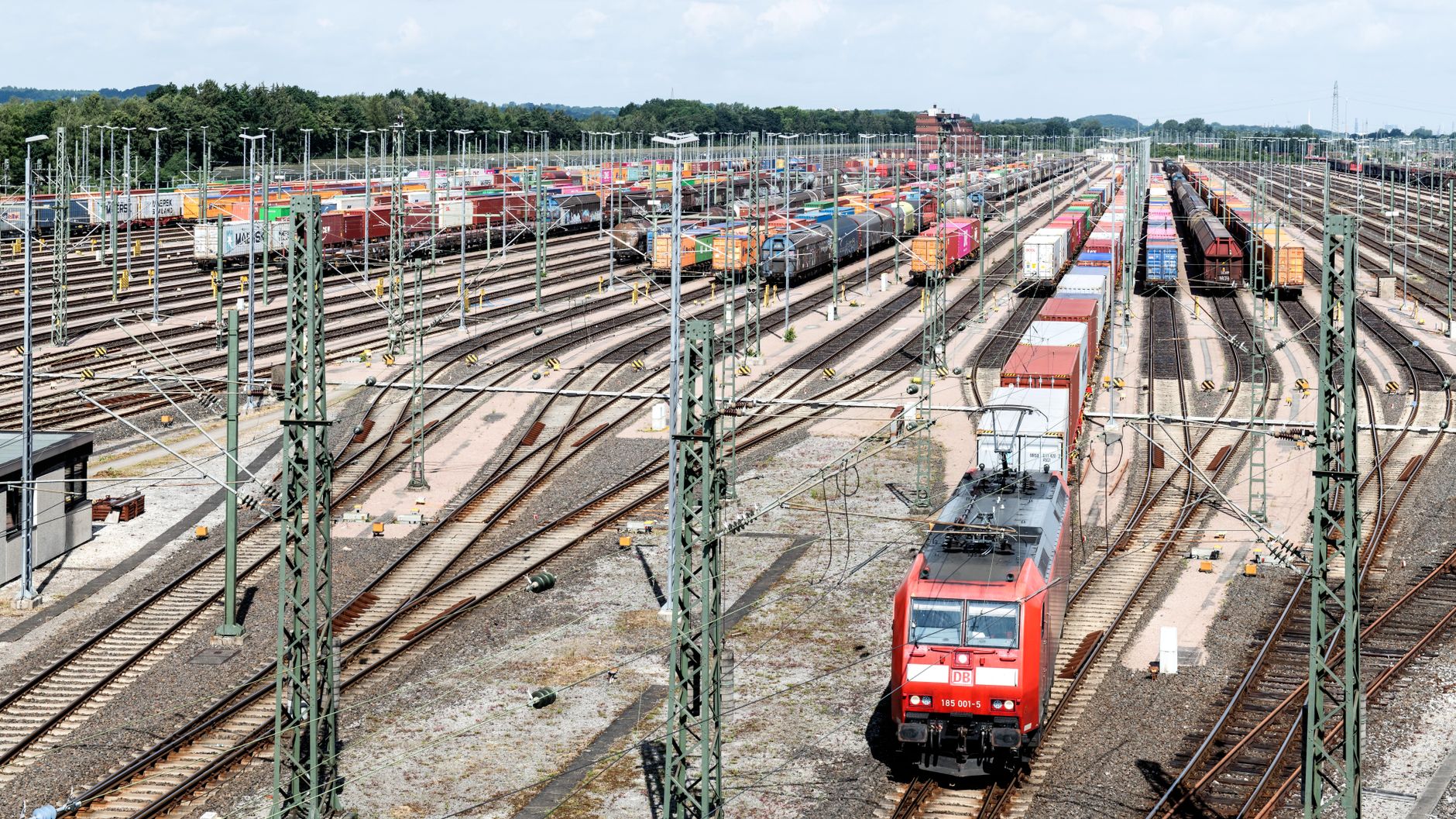 Intermodal rail yard with shipping containers illustrating lane-specific freight operations