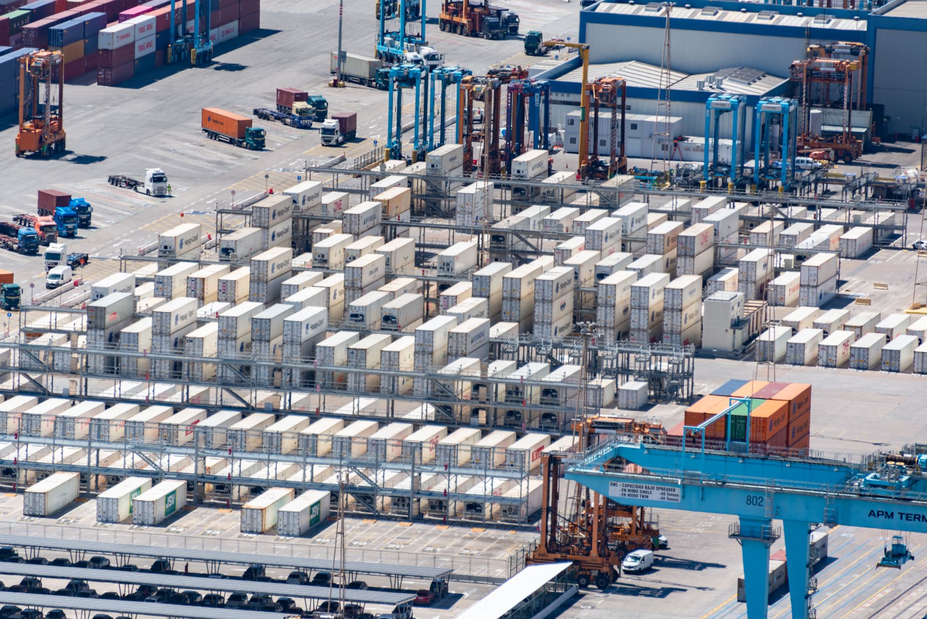 Aerial view of an intermodal container port with rows of shipping containers