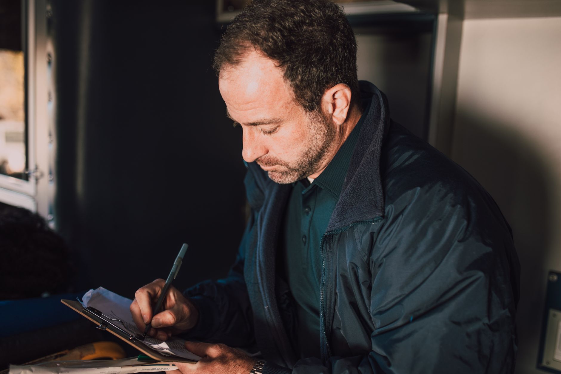 A warehouse manager examining logistics reports on a tablet inside a fulfillment center