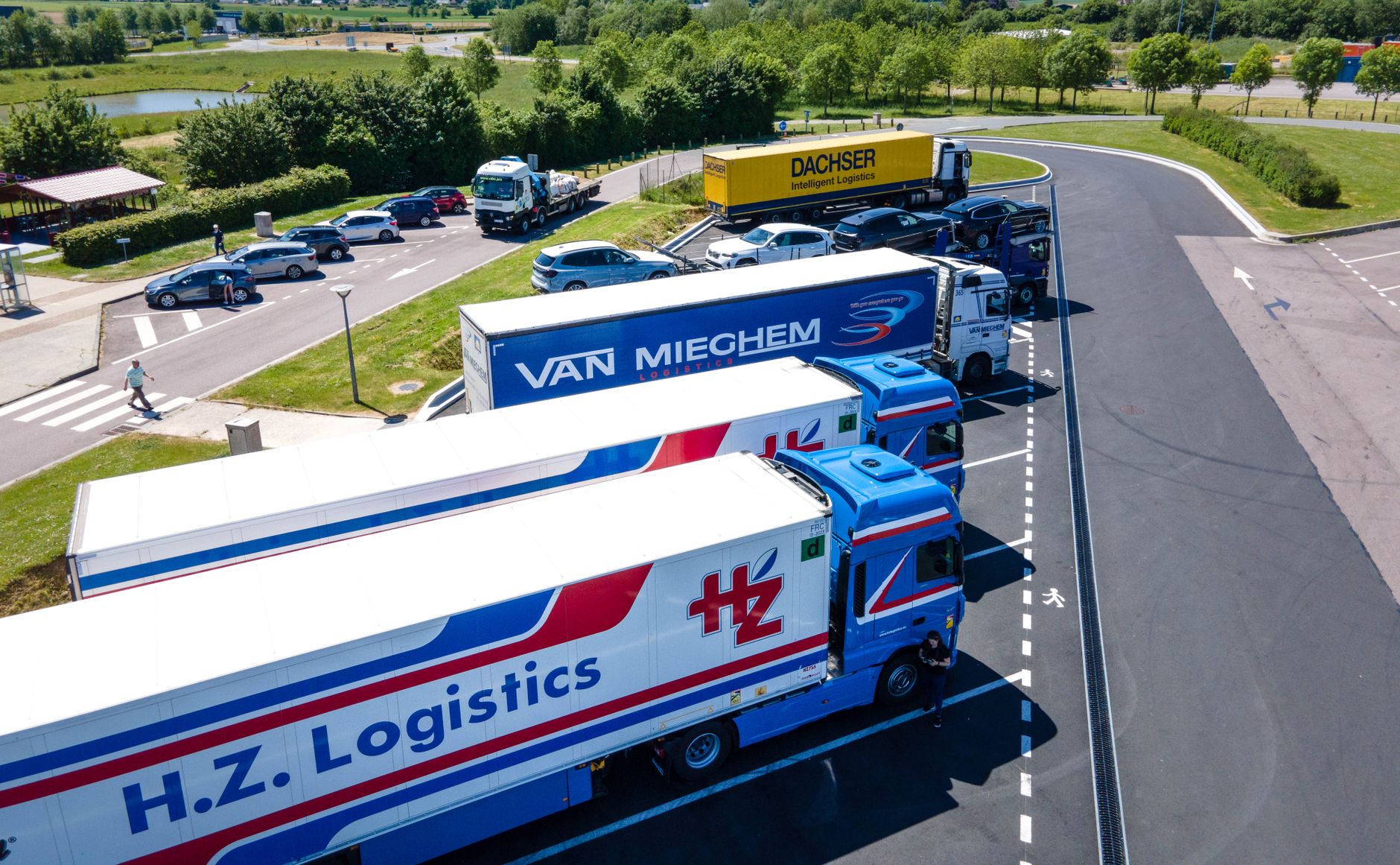 Aerial view of cargo trucks moving along a major highway
